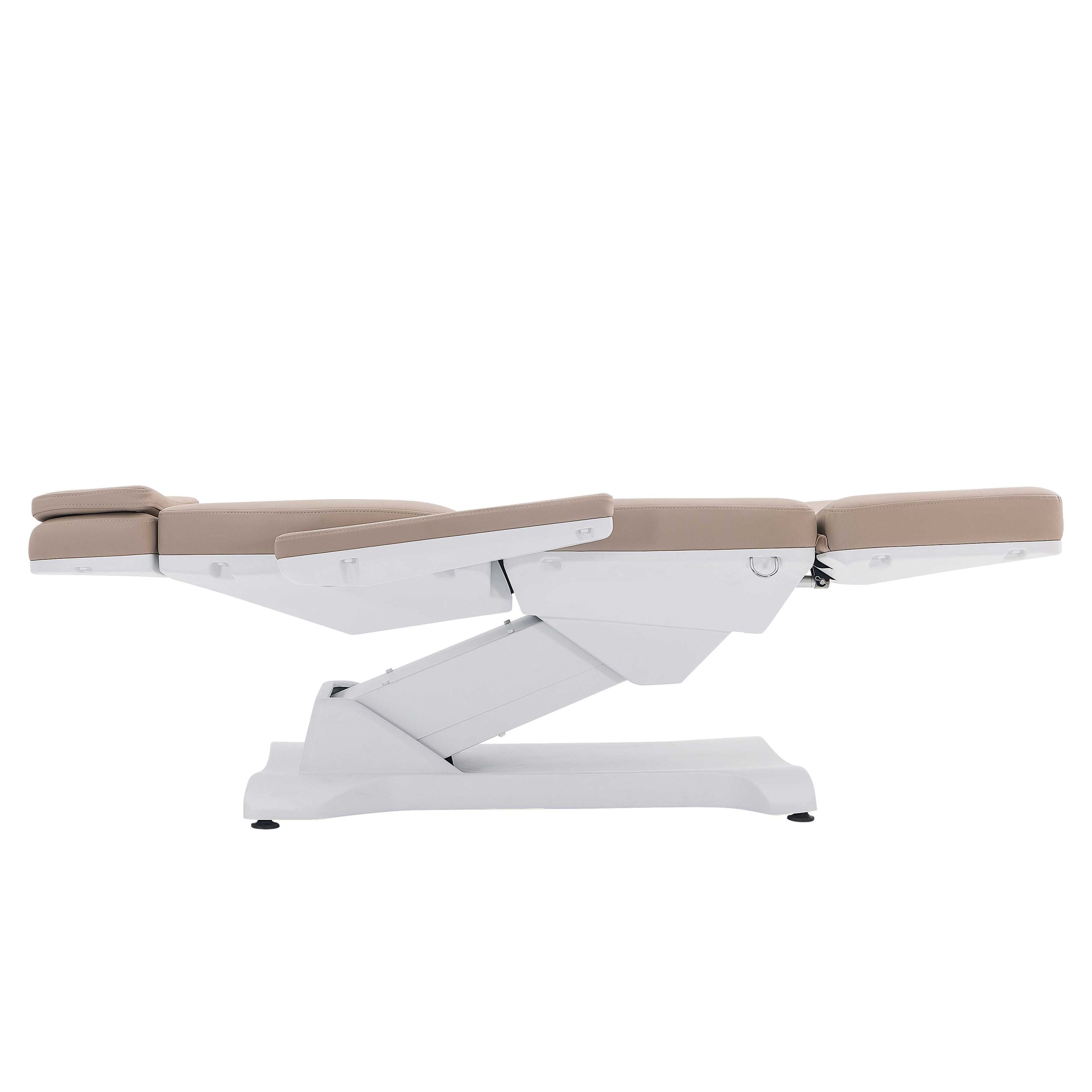 Medical examination chair with beige upholstery and a reclining leg rest on a white base.