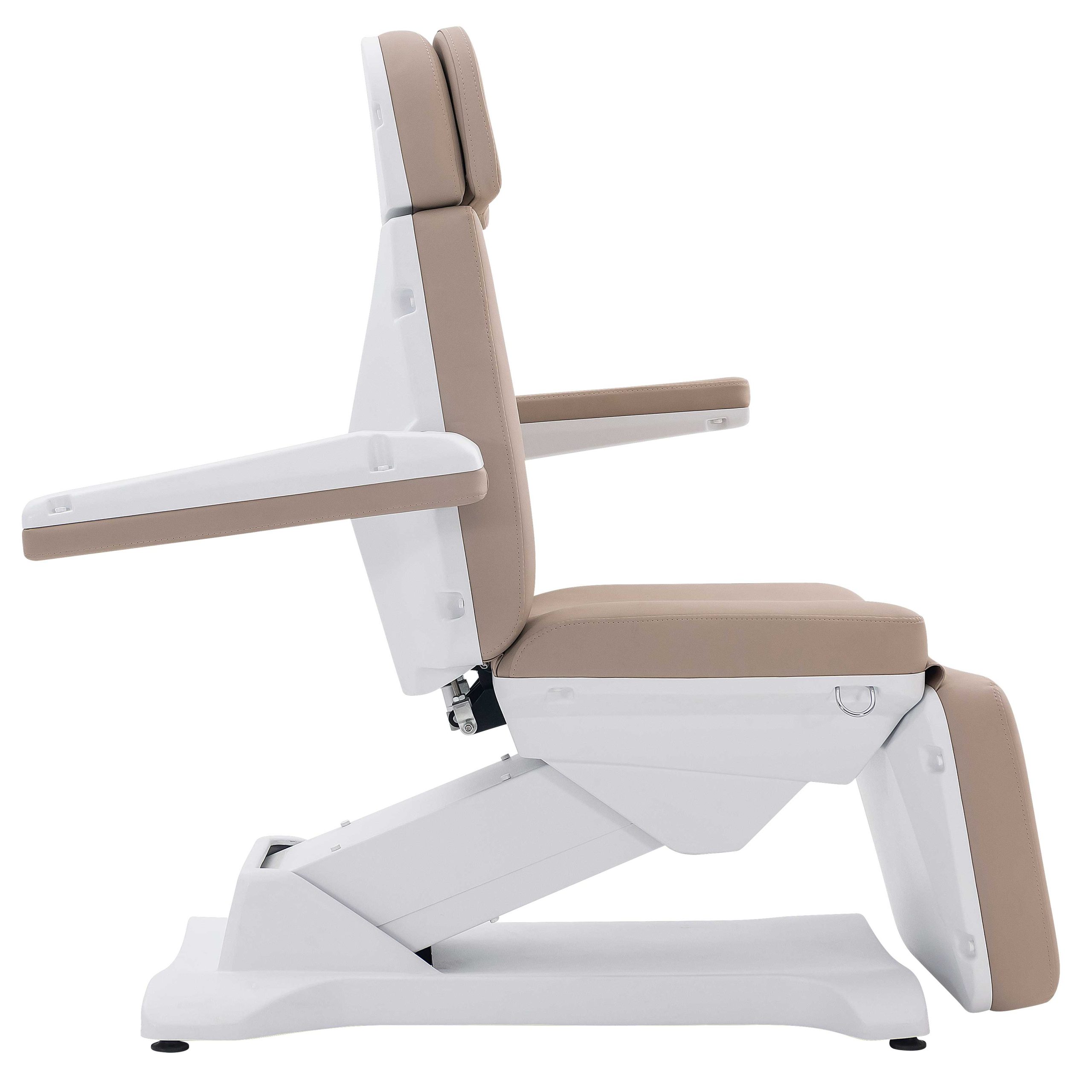 Side view of a beige upholstered medical reclining chair with a white metal frame and extendable footrest against a white background.