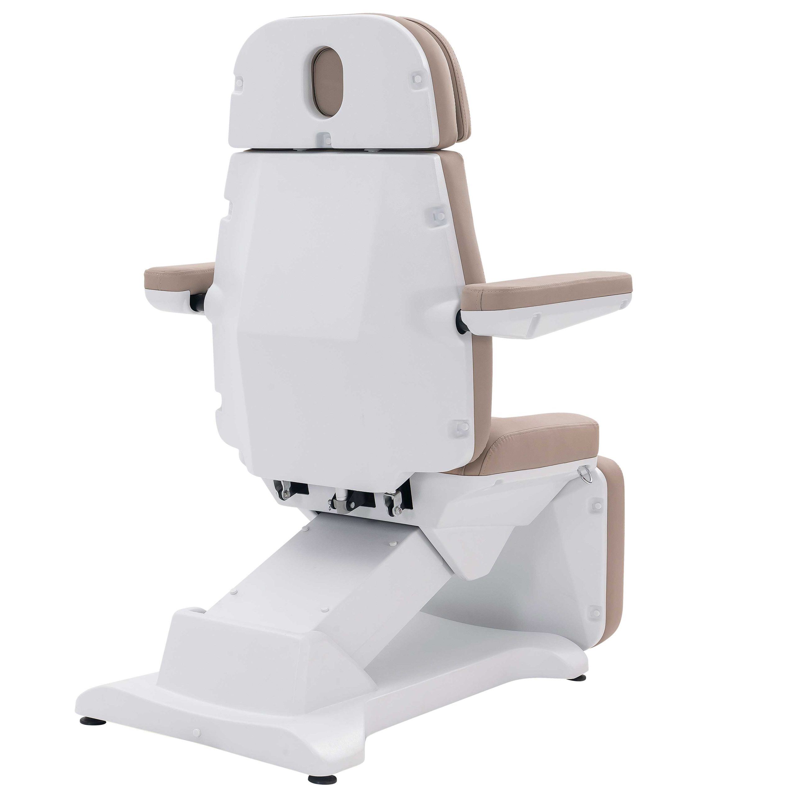 Medical examination chair with white frame and beige cushions, side view.