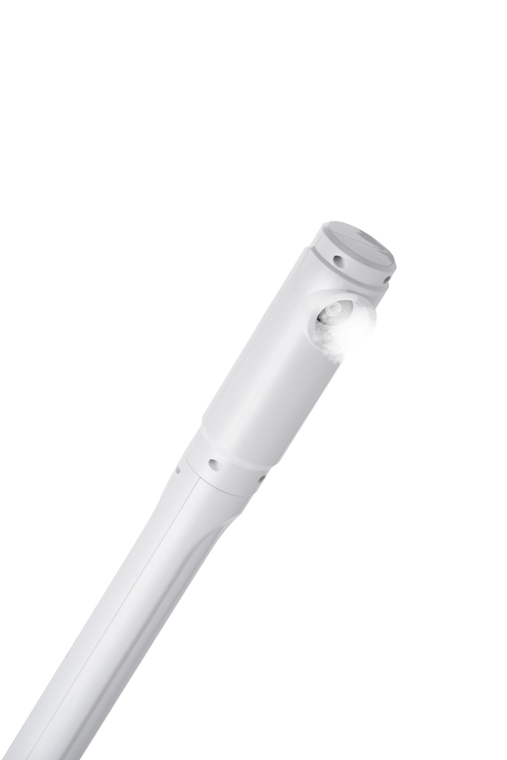Close-up of a white pen-shaped medical device emitting a small mist from its nozzle at the top-right.