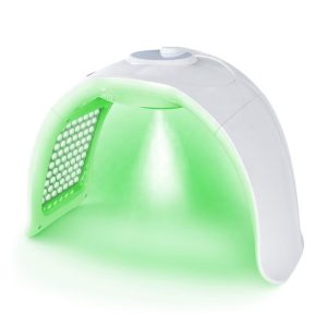 Compact white dental curing light with a bright green LED panel emitting light from its opening