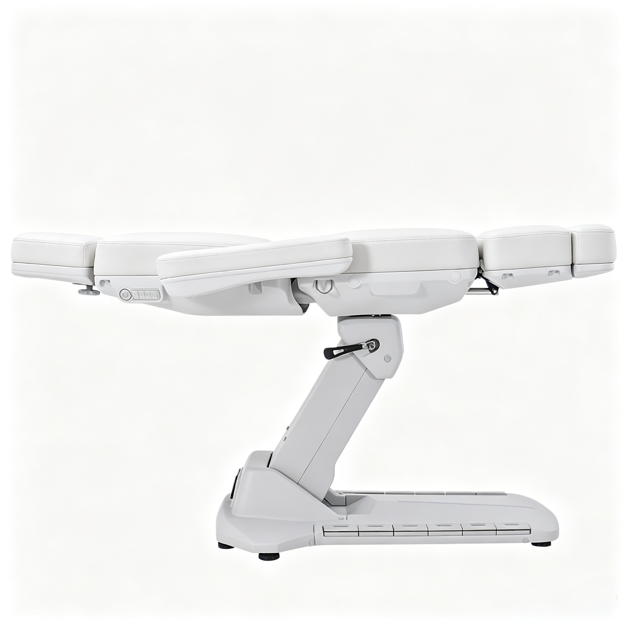 Side view of a white, segmented medical recliner chair with cushioned upholstery and a metal base/arm mechanism visible in a clinical setting.