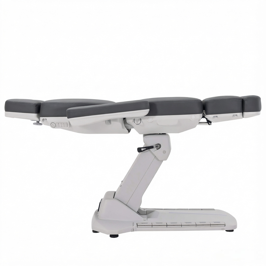 Adjustable medical examination table with cushioned gray sections and white base in a side view